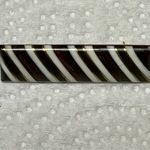 Vintage wooden lapel pin/brooch with inlaid brass, strips of wood and bones.